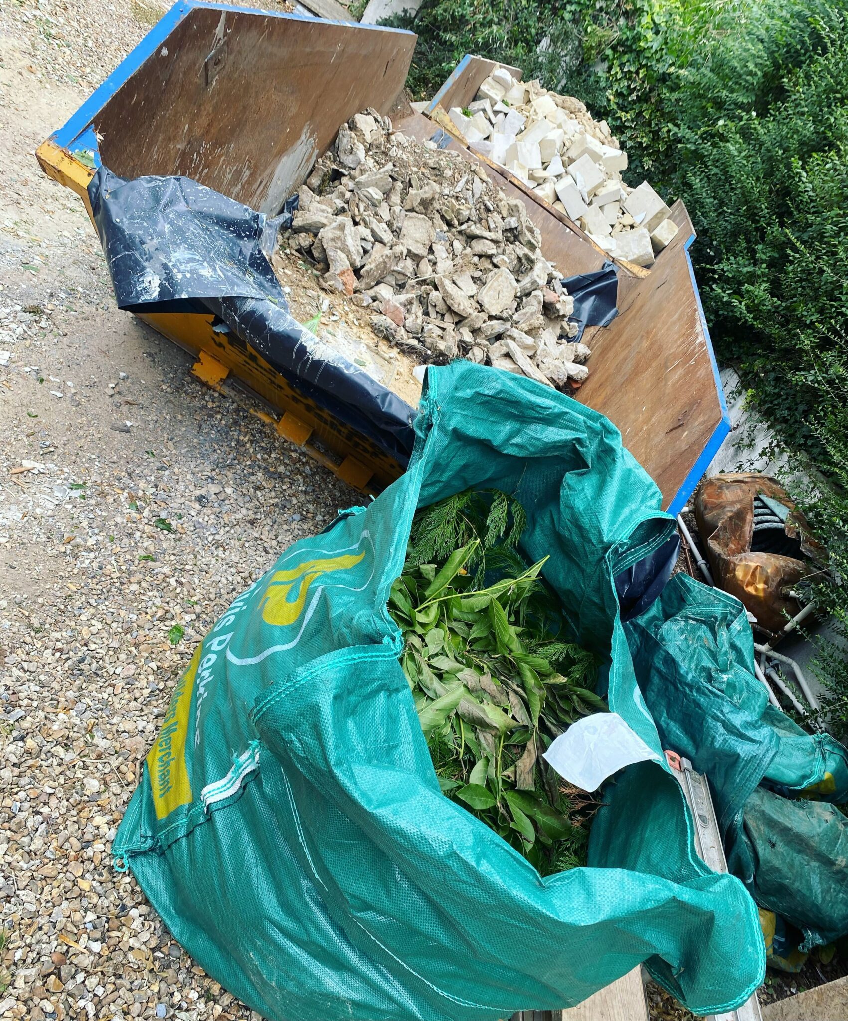 Bags of garden waste and rubble ready to be taken away