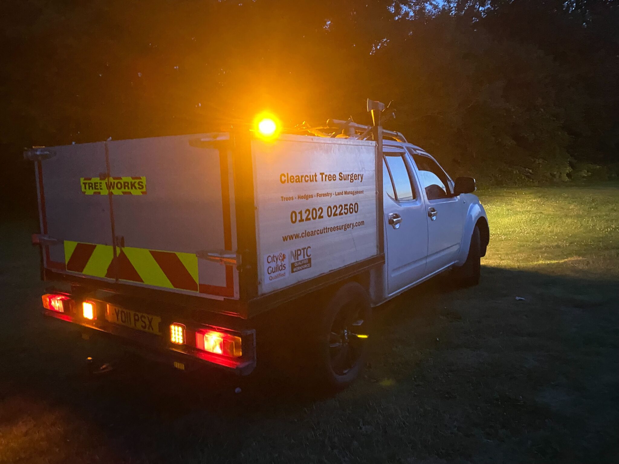 The Clearcut pickup with its beacon on at a night job