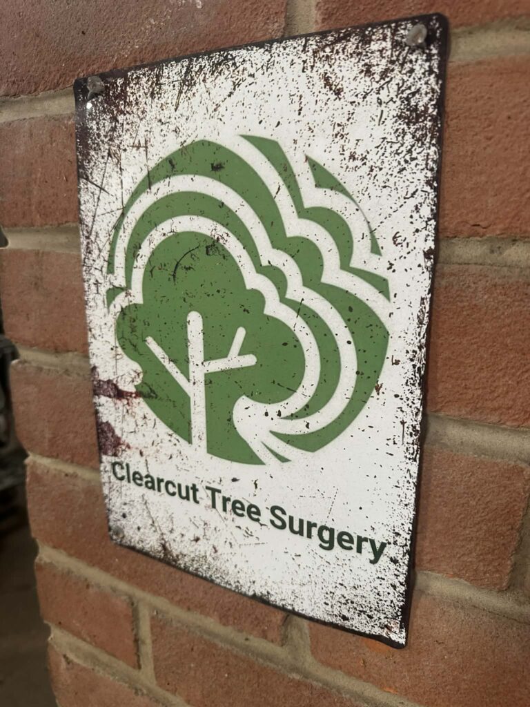 The Clearcut Tree Surgery sign on a brick wall
